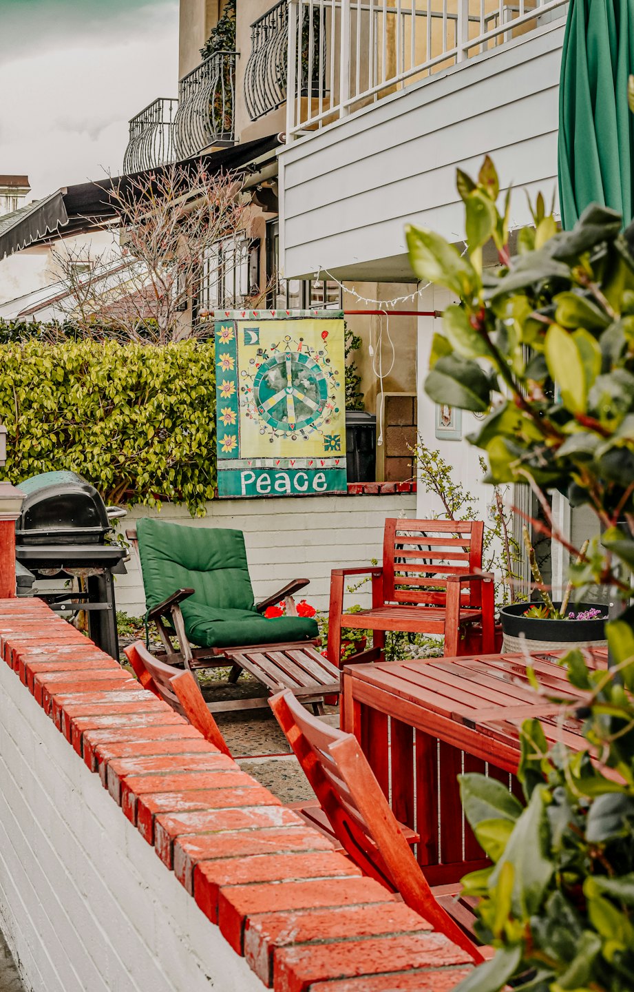 Outdoor patio with furniture and a peace sign flag.