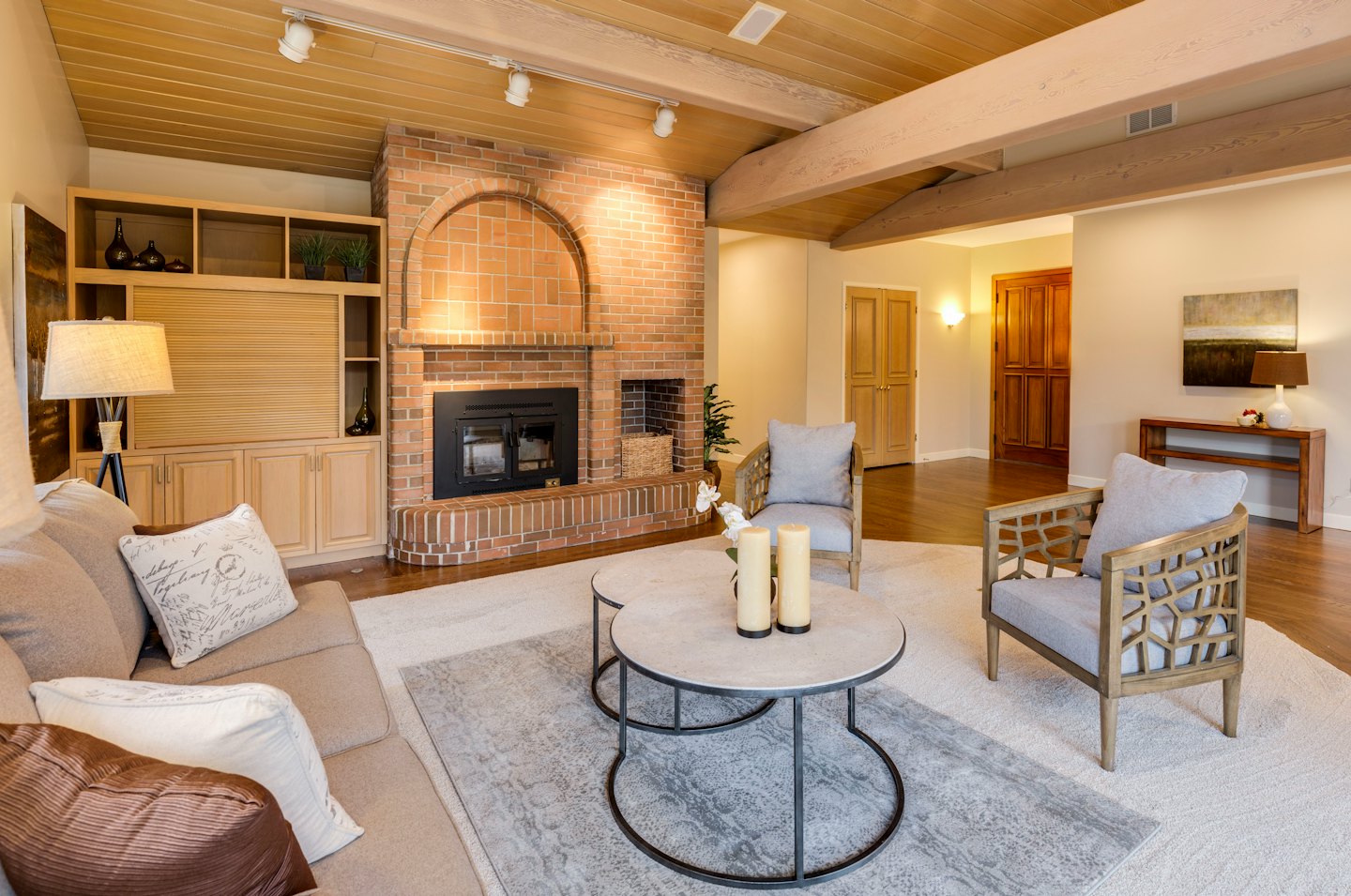 Cozy living room with brick fireplace and built-in shelves.